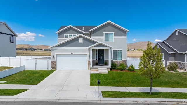 1815 E Thunder Gulch Rd, Eagle Mountain, UT 84005 - view of front of home with stone siding, stucco siding, driveway, and a mountain view