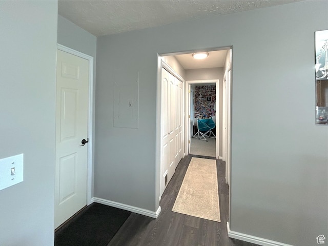 434 S 2nd E, Soda Springs, ID 83276 - hall featuring dark wood-style flooring, baseboards, electric panel, and a textured ceiling