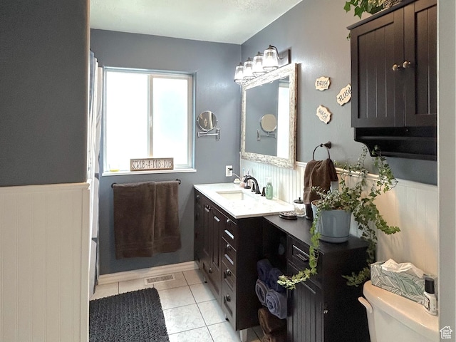434 S 2nd E, Soda Springs, ID 83276 - full bath featuring vanity, toilet, a wainscoted wall, and tile patterned floors