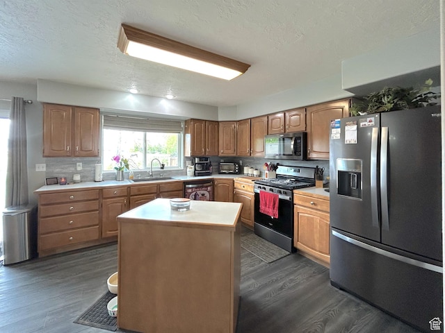 434 S 2nd E, Soda Springs, ID 83276 - kitchen with appliances with stainless steel finishes, a sink, dark wood-style flooring, light countertops, and a textured ceiling