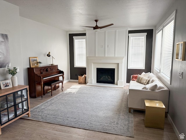 934 W 2740 N, Lehi, UT 84043 - living room with wood finished floors, a ceiling fan, a large fireplace, and baseboards