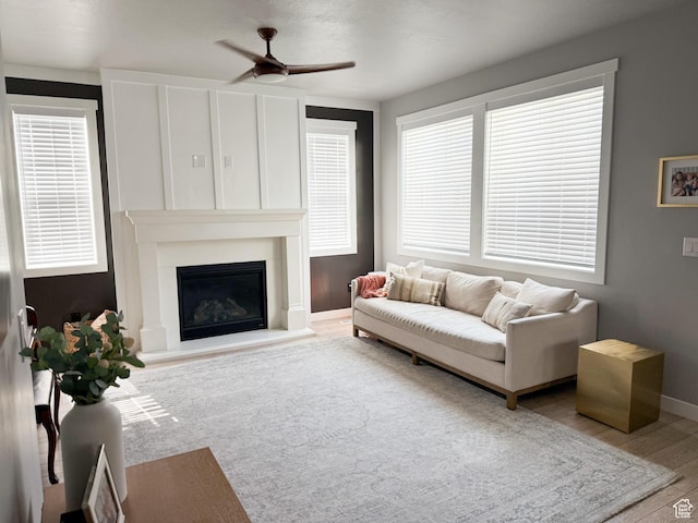 934 W 2740 N, Lehi, UT 84043 - living room with ceiling fan, wood finished floors, a glass covered fireplace, and baseboards