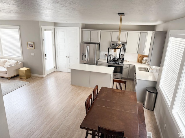 934 W 2740 N, Lehi, UT 84043 - dining space with healthy amount of natural light, a textured ceiling, light wood finished floors, and baseboards