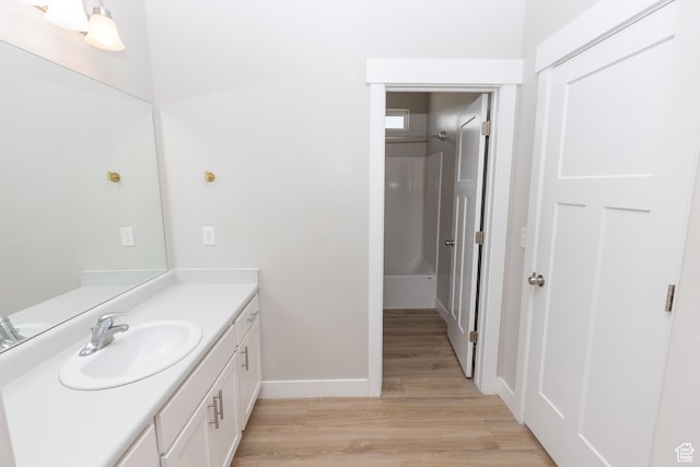 66 W Silver Springs Dr, Vineyard, UT 84059 - full bathroom featuring vanity, wood finished floors, baseboards, a shower, and a tub