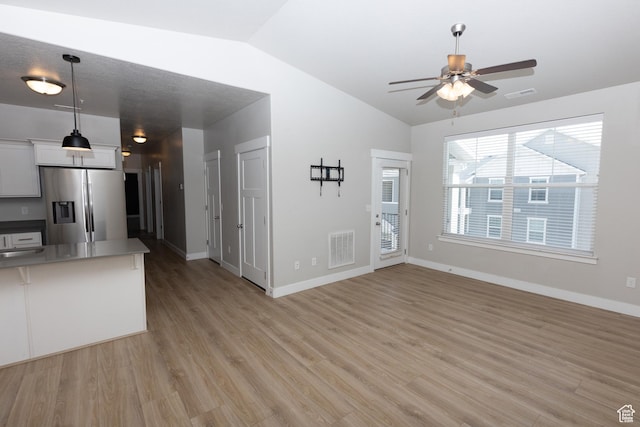 66 W Silver Springs Dr, Vineyard, UT 84059 - unfurnished living room with vaulted ceiling, ceiling fan, light wood-style flooring, and baseboards