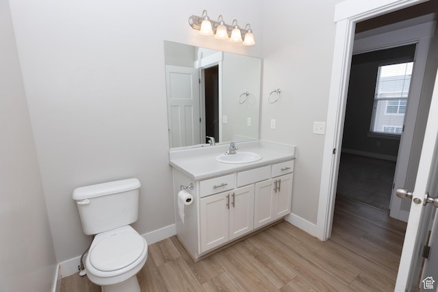 66 W Silver Springs Dr, Vineyard, UT 84059 - bathroom with wood finished floors, vanity, baseboards, and toilet