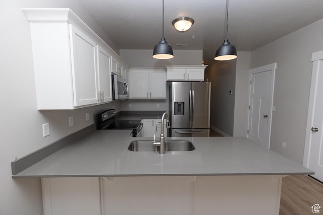 66 W Silver Springs Dr, Vineyard, UT 84059 - kitchen with appliances with stainless steel finishes, a sink, a peninsula, white cabinets, and hanging light fixtures
