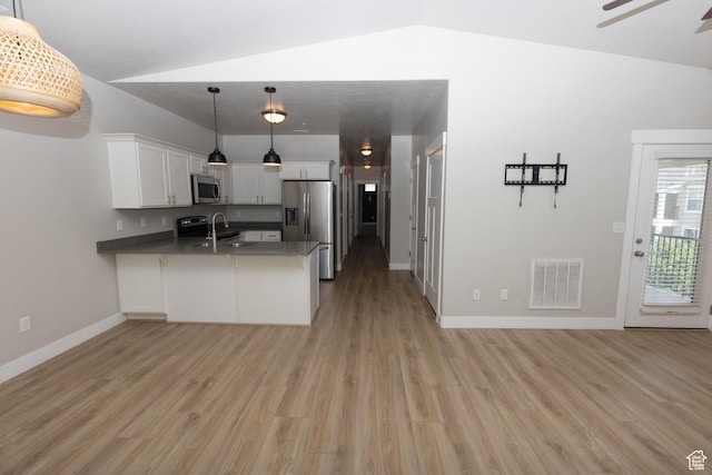 66 W Silver Springs Dr, Vineyard, UT 84059 - kitchen featuring stainless steel appliances, a peninsula, light wood-style floors, and vaulted ceiling