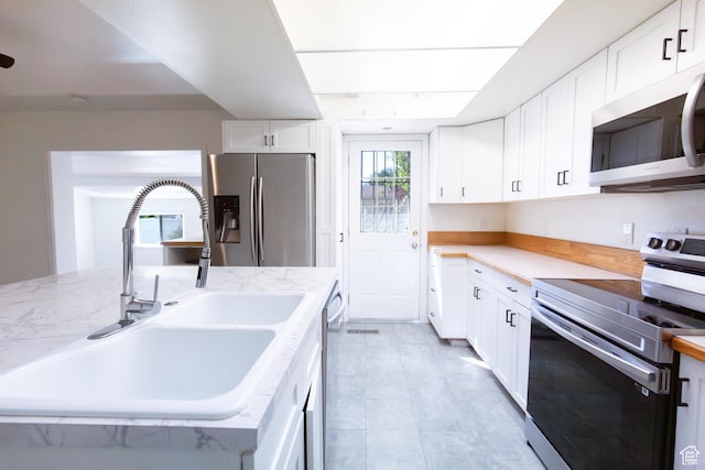 875 W 1130 N, Orem, UT 84057 - kitchen with stainless steel appliances, a sink, white cabinets, and light stone counters