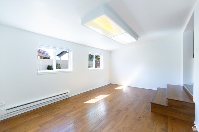 875 W 1130 N, Orem, UT 84057 - unfurnished room featuring a baseboard heating unit, wood finished floors, and baseboards