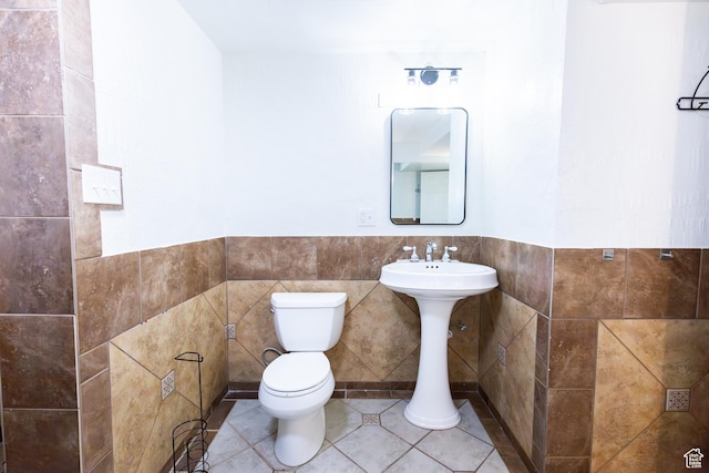 875 W 1130 N, Orem, UT 84057 - bathroom featuring toilet, tile walls, a wainscoted wall, and tile patterned floors