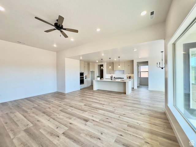 525 N 3380 W Unit 16, Hurricane, UT 84737 - unfurnished living room with light wood-style floors, recessed lighting, ceiling fan, and baseboards