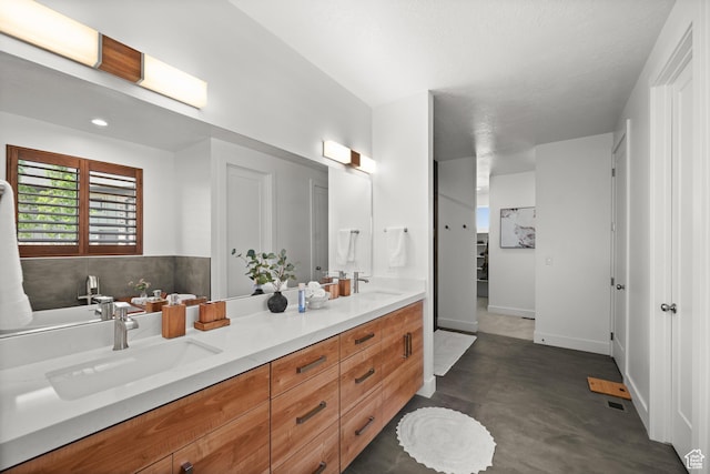 507 W Windmill Gate Cv, Draper, UT 84020 - full bathroom with double vanity, finished concrete floors, and baseboards