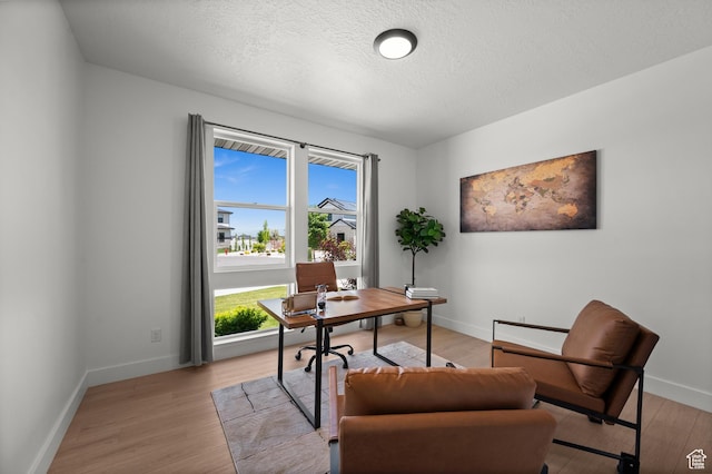 507 W Windmill Gate Cv, Draper, UT 84020 - office with healthy amount of natural light, a textured ceiling, light wood-style floors, and baseboards