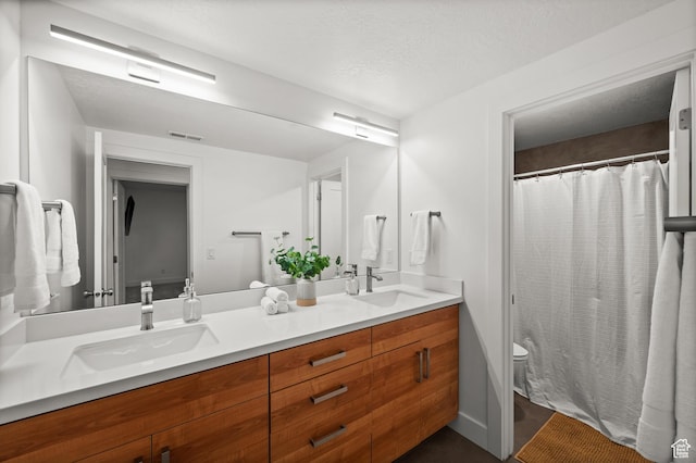 507 W Windmill Gate Cv, Draper, UT 84020 - bathroom featuring toilet, double vanity, and curtained shower