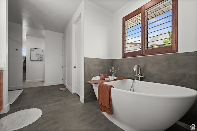 507 W Windmill Gate Cv, Draper, UT 84020 - bathroom with concrete floors and a soaking tub