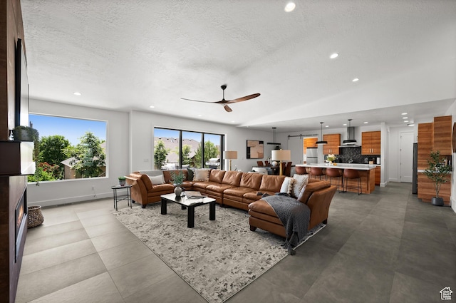 507 W Windmill Gate Cv, Draper, UT 84020 - living room featuring a ceiling fan, recessed lighting, a textured ceiling, and baseboards