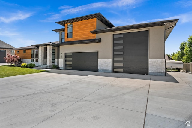 507 W Windmill Gate Cv, Draper, UT 84020 - modern home with stone siding, driveway, stucco siding, and a garage