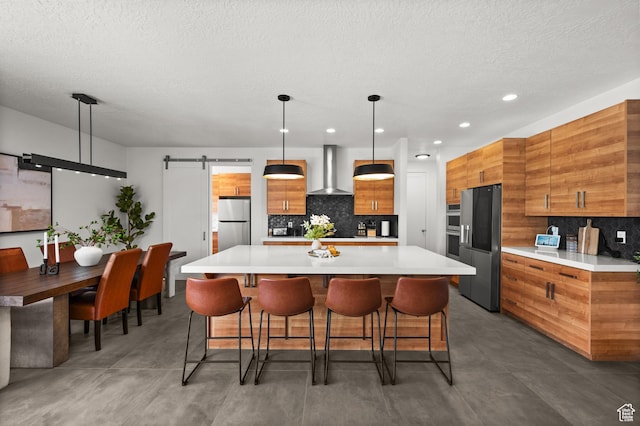 507 W Windmill Gate Cv, Draper, UT 84020 - kitchen with wall chimney exhaust hood, appliances with stainless steel finishes, brown cabinetry, modern cabinets, and a textured ceiling