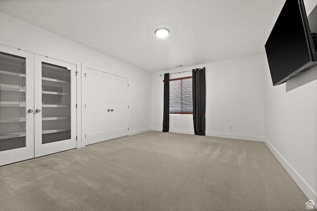 507 W Windmill Gate Cv, Draper, UT 84020 - unfurnished bedroom with light colored carpet, baseboards, and two closets