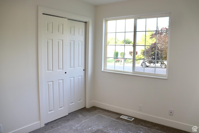 579 N 430 E Unit 2, Tooele, UT 84074 - unfurnished bedroom featuring baseboards, a closet, and carpet flooring