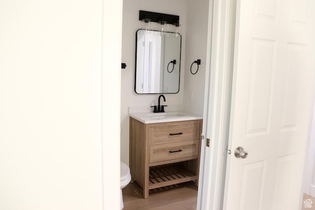 579 N 430 E Unit 2, Tooele, UT 84074 - bathroom with vanity, toilet, and wood finished floors
