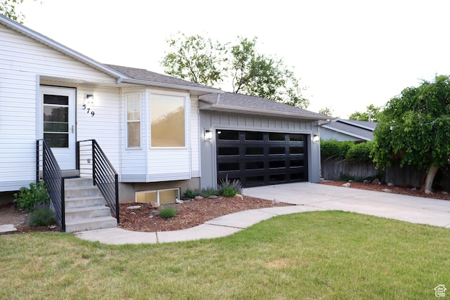 579 N 430 E Unit 2, Tooele, UT 84074 - view of front of house with concrete driveway, an attached garage, entry steps, and a front yard