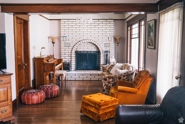 201 Bannock St, Malad City, ID 83252 - living area with beamed ceiling, wood finished floors, a brick fireplace, and crown molding