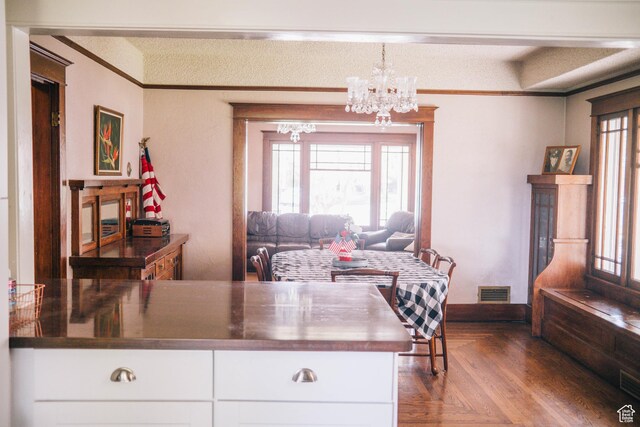201 Bannock St, Malad City, ID 83252 - kitchen featuring a chandelier, plenty of natural light, white cabinets, and ornamental molding