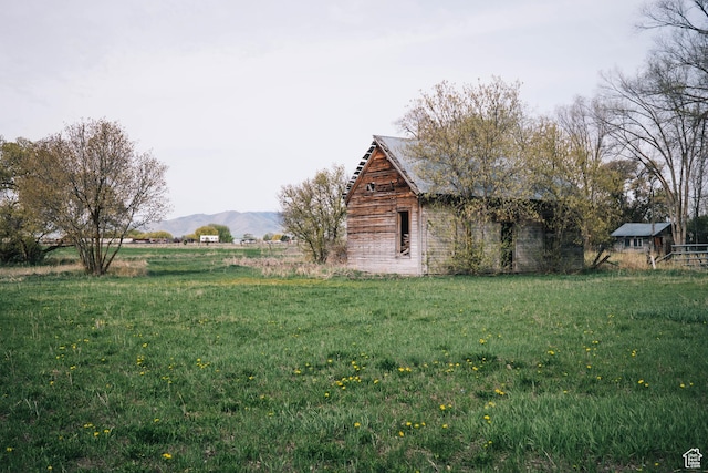 201 Bannock St, Malad City, ID 83252 - view of grassy yard with a mountain view, a barn, a view of rural / pastoral area, and an outdoor structure