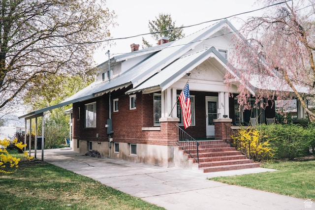201 Bannock St, Malad City, ID 83252 - view of front of home featuring brick siding, covered porch, and a chimney