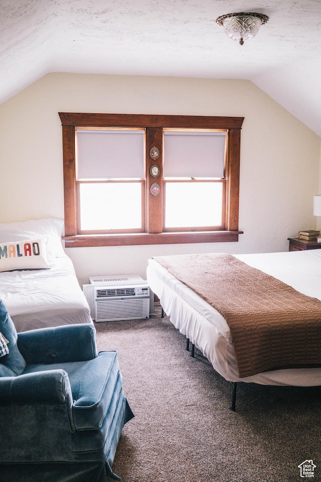 201 Bannock St, Malad City, ID 83252 - bedroom with vaulted ceiling, carpet flooring, and an AC wall unit