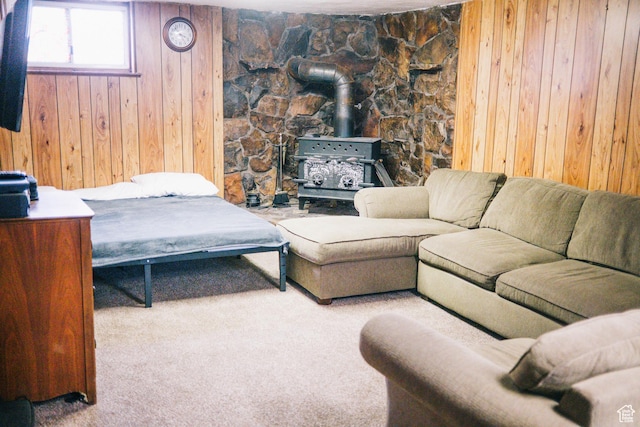 201 Bannock St, Malad City, ID 83252 - living room featuring wooden walls, carpet floors, and a wood stove
