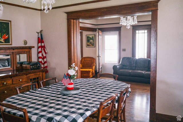 201 Bannock St, Malad City, ID 83252 - dining room with a chandelier, crown molding, wood finished floors, and a textured wall