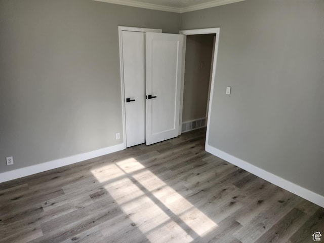 713 E 2nd St, Ogden, UT 84404 - unfurnished bedroom featuring crown molding, wood finished floors, and baseboards