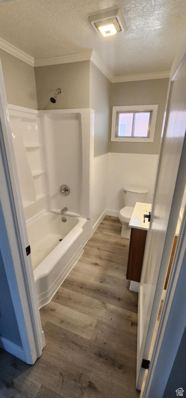 713 E 2nd St, Ogden, UT 84404 - bathroom with a textured ceiling, toilet, vanity, shower / tub combination, and crown molding