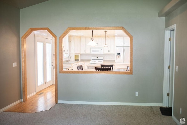 1271 S Main St S, Mapleton, UT 84664 - kitchen with white appliances, carpet flooring, baseboards, a sink, and pendant lighting