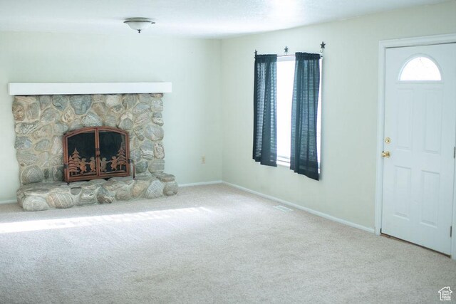 1271 S Main St S, Mapleton, UT 84664 - unfurnished living room featuring carpet, a stone fireplace, and baseboards