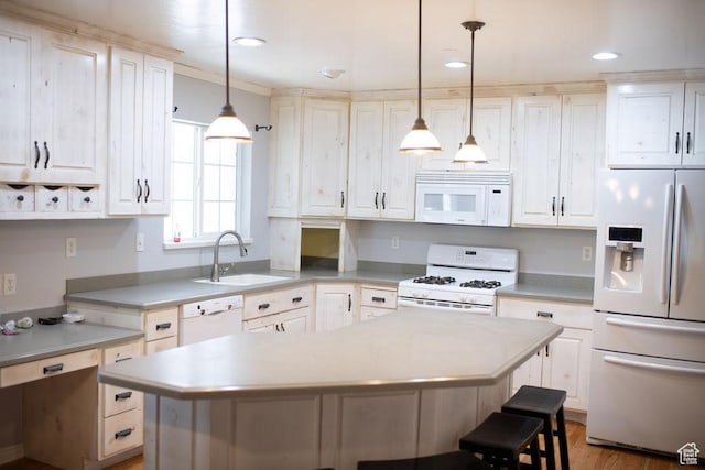 1271 S Main St S, Mapleton, UT 84664 - kitchen with white appliances, a sink, light countertops, a kitchen bar, and recessed lighting