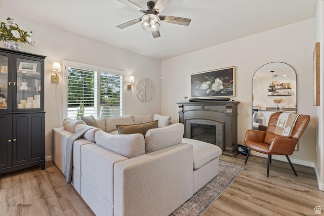 819 E 12085 S, Draper, UT 84020 - living area with light wood-type flooring, ceiling fan, a glass covered fireplace, and baseboards