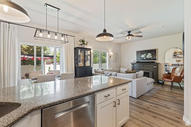 819 E 12085 S, Draper, UT 84020 - kitchen with stainless steel dishwasher, a fireplace, white cabinetry, light wood-style flooring, and ceiling fan