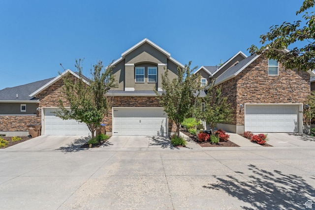 819 E 12085 S, Draper, UT 84020 - view of front facade featuring stone siding, driveway, stucco siding, and an attached garage