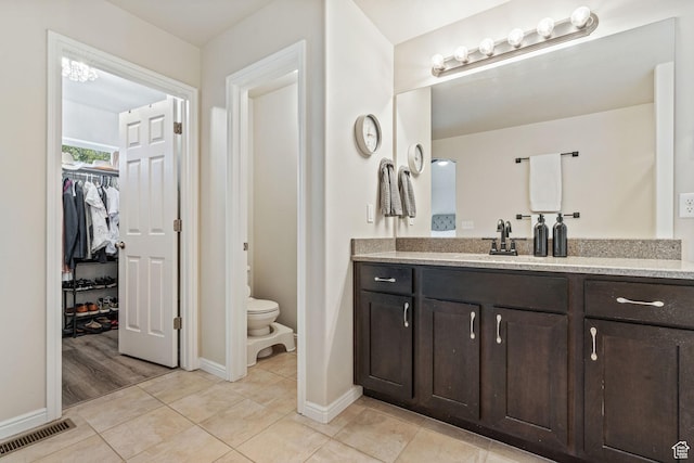 819 E 12085 S, Draper, UT 84020 - full bathroom with vanity, baseboards, a walk in closet, toilet, and tile patterned flooring