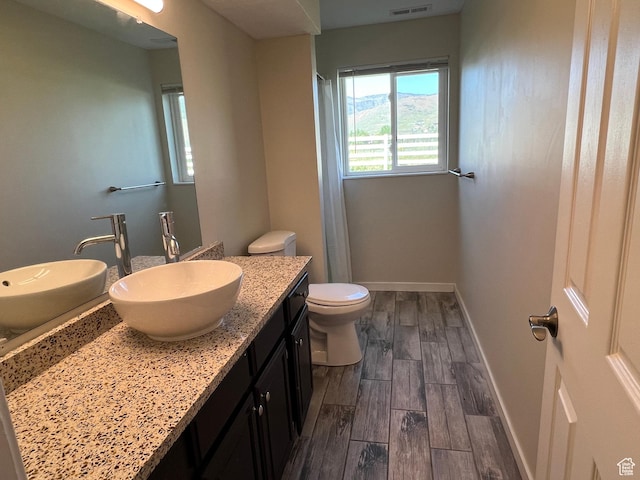 8842 E 500 S, Huntsville, UT 84317 - full bath with wood finished floors, vanity, baseboards, toilet, and a shower with curtain