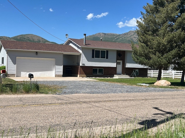 8842 E 500 S, Huntsville, UT 84317 - split foyer home featuring a mountain view, a garage, and gravel driveway