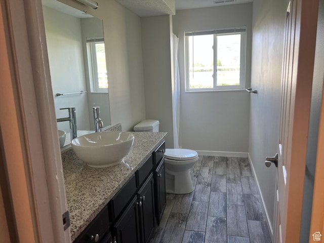 8842 E 500 S, Huntsville, UT 84317 - full bath with toilet, vanity, wood finished floors, and baseboards