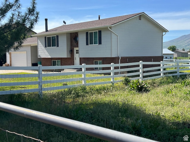 8842 E 500 S, Huntsville, UT 84317 - split foyer home with an attached garage and a mountain view
