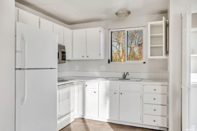 3185 S 4060 W, Salt Lake City, UT 84120 - kitchen featuring white appliances, a sink, light countertops, and white cabinetry