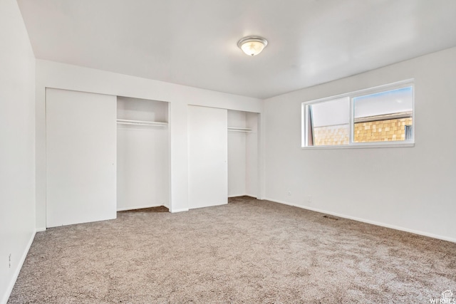 3185 S 4060 W, Salt Lake City, UT 84120 - unfurnished bedroom with multiple closets, carpet floors, and baseboards