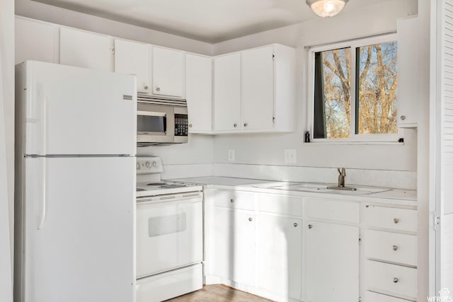 3185 S 4060 W, Salt Lake City, UT 84120 - kitchen featuring white appliances, light countertops, a sink, and white cabinets